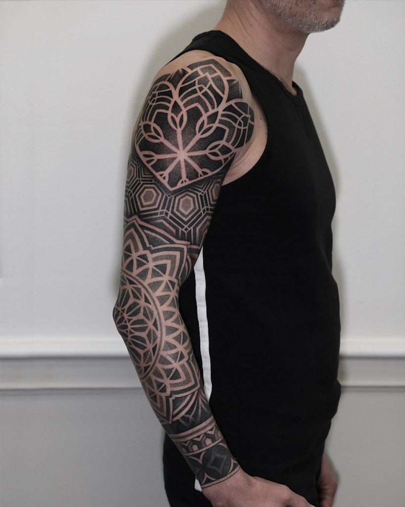 Geometric fullsleeve on a man's right arm. Dotwork technique. 